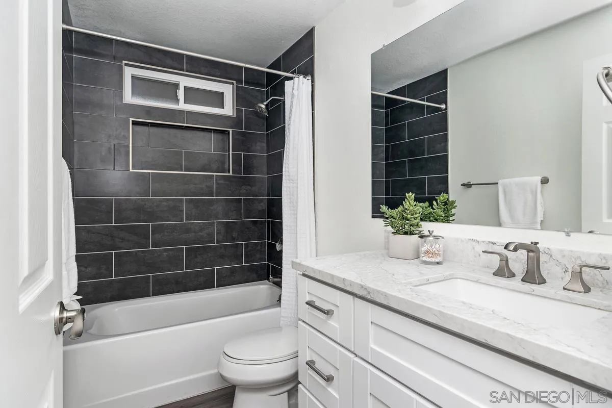 16470 Avenida Venusto, Unit F Rancho Bernardo, CA 92128 - Photo 25 of 30 a bathroom with a granite countertop sink a toilet and shower