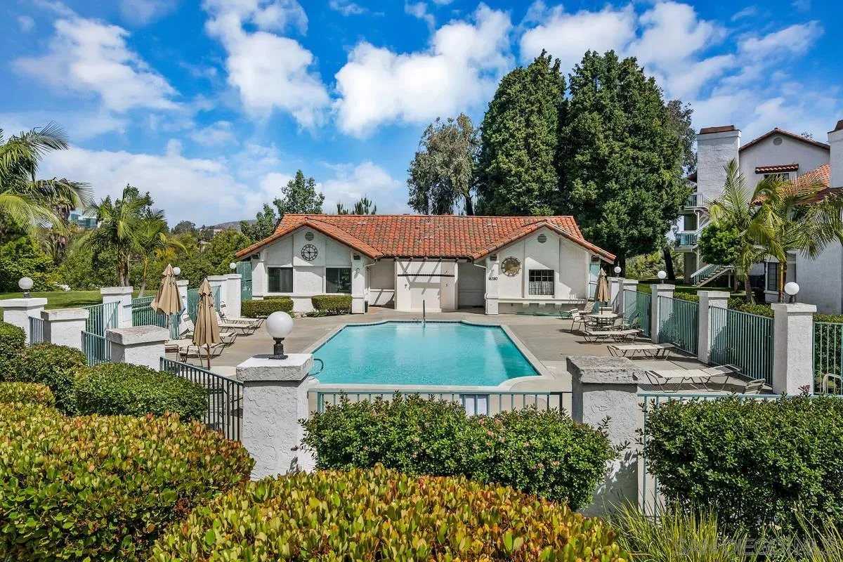 16470 Avenida Venusto, Unit F Rancho Bernardo, CA 92128 - Photo 27 of 30 a aerial view of a house with a yard and table and chairs under an umbrella