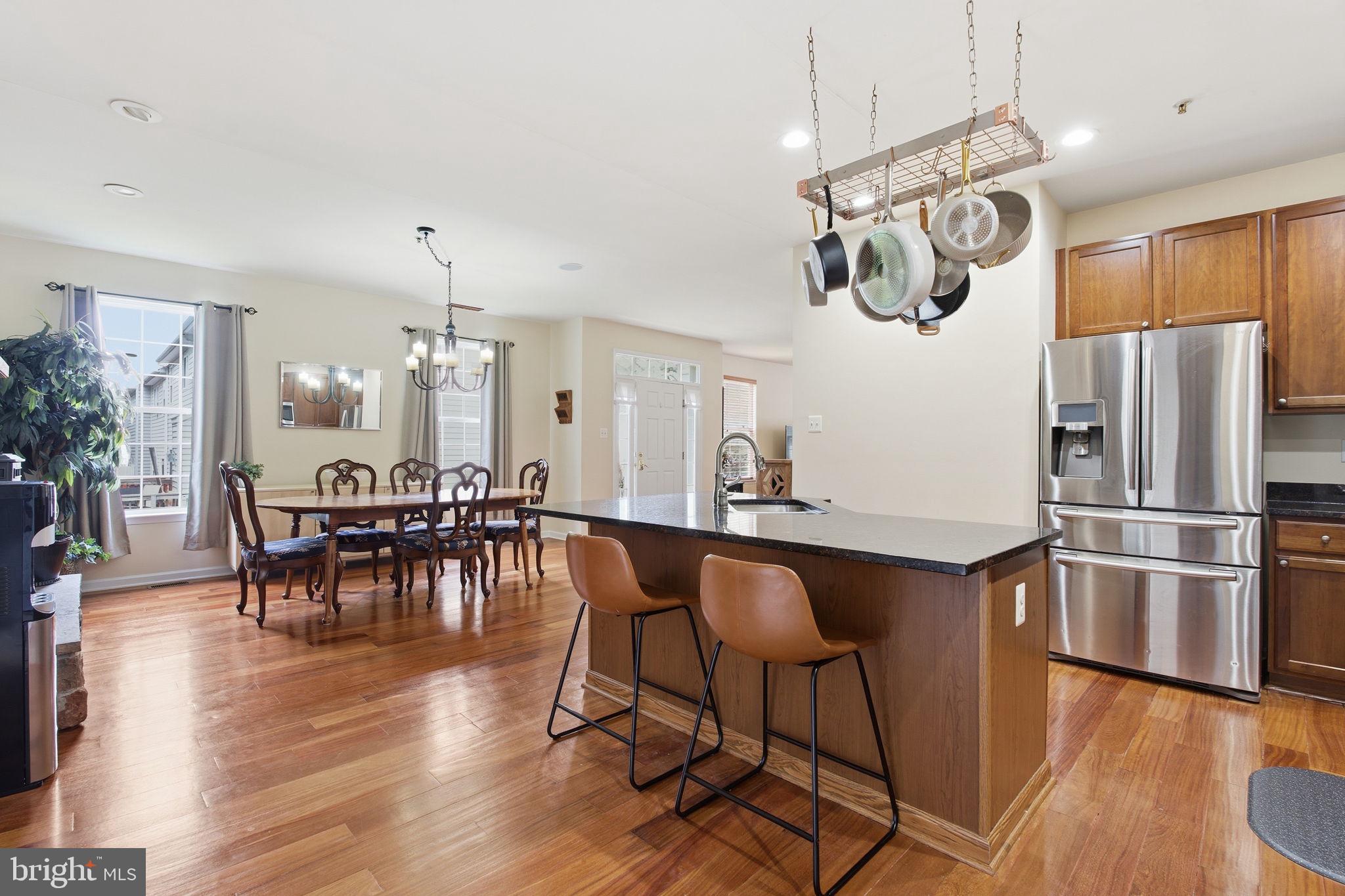 800 Rustic Court Perryville, MD 21903 - Photo 11 of 35 a kitchen with stainless steel appliances granite countertop a table chairs refrigerator and couches