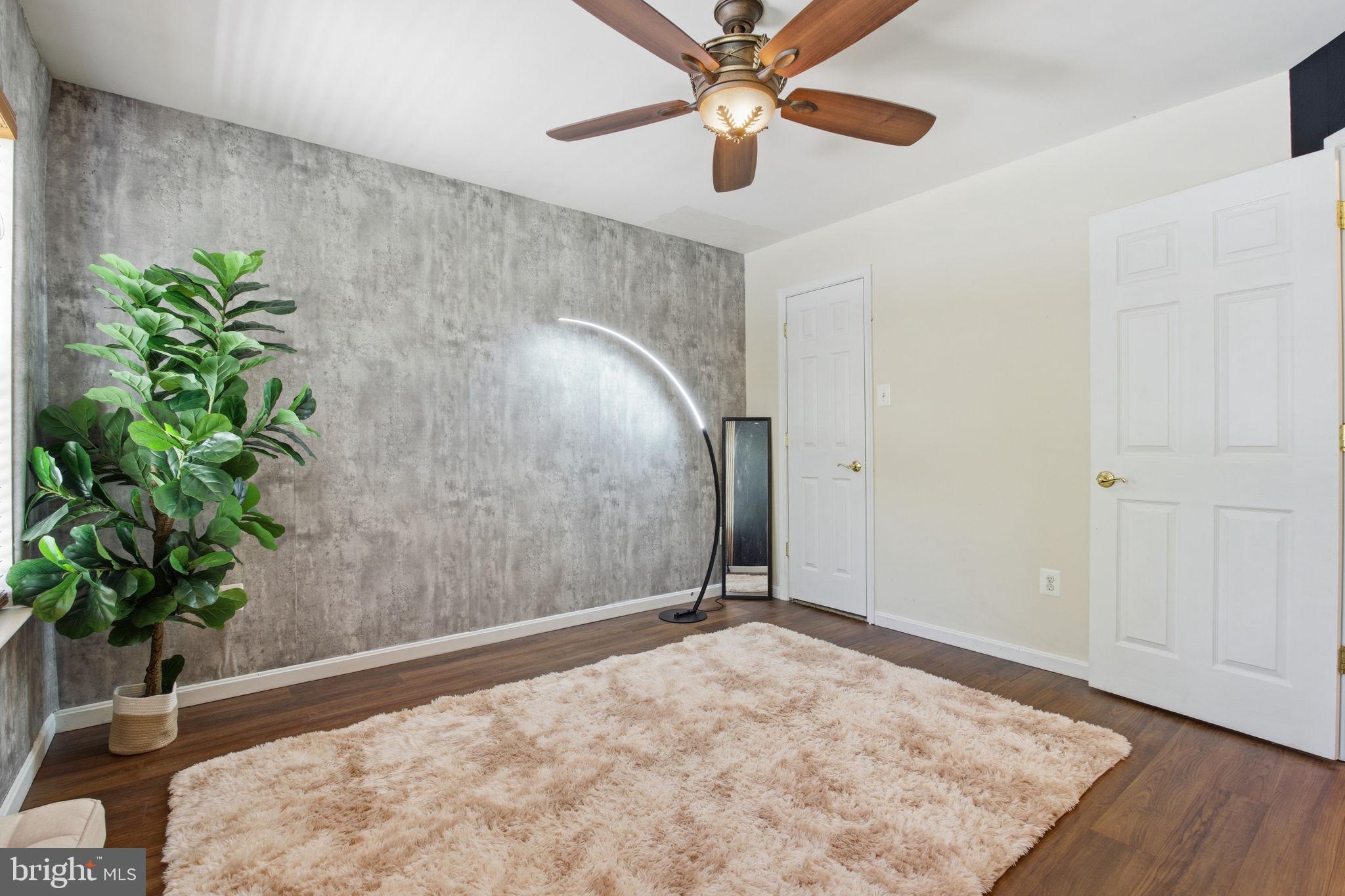 800 Rustic Court Perryville, MD 21903 - Photo 21 of 35 an empty room with potted plants and wooden floor