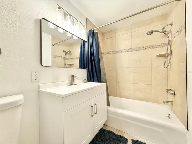 a bedroom with bed and a chandelier