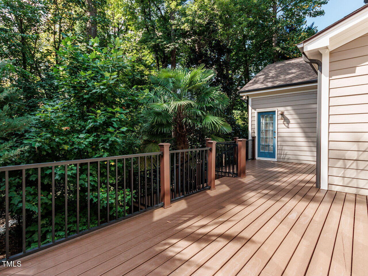 4613 Wee Burn Trail Raleigh, NC 27612 - Photo 40 of 49 The large deck is newly reconstructed (2022) with posts, decking and railings. The deck is also screened by trees to provide some degree of privacy.