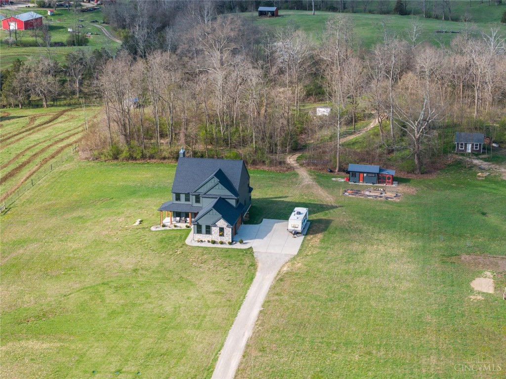 Perched on a verdant hillside, this expansive estate offers tranquil living amidst nature's embrace.