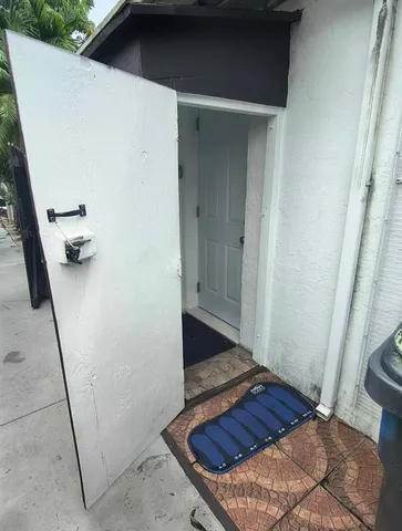 a white toilet sitting next to a shower