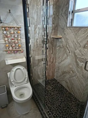 a bathroom with a sink mirror vanity and toilet