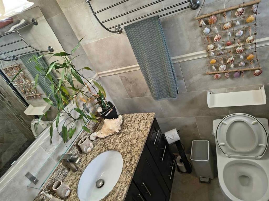 5741 Southwest 24th Avenue, Unit B Fort Lauderdale, FL 33312 - Photo 9 of 9 a bathroom with a sink mirror vanity and toilet