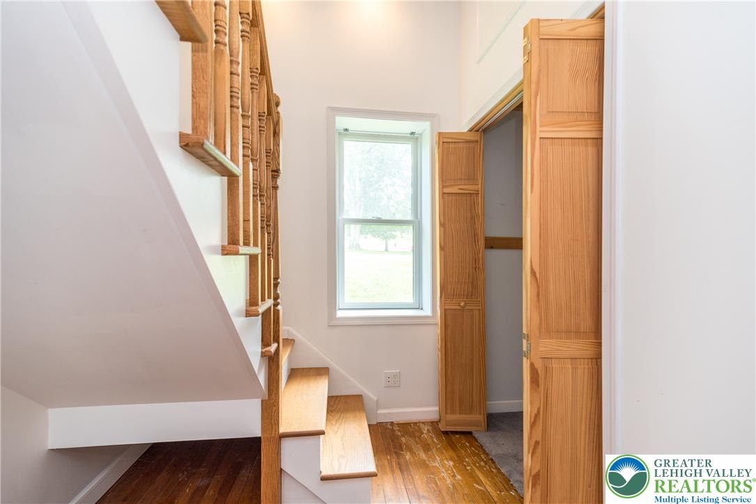 1815 Leithsville Road Hellertown, PA 18055 - Photo 13 of 38 Hardwood flooring extends throughout the entry, framing the solid wood staircase with classic balusters.