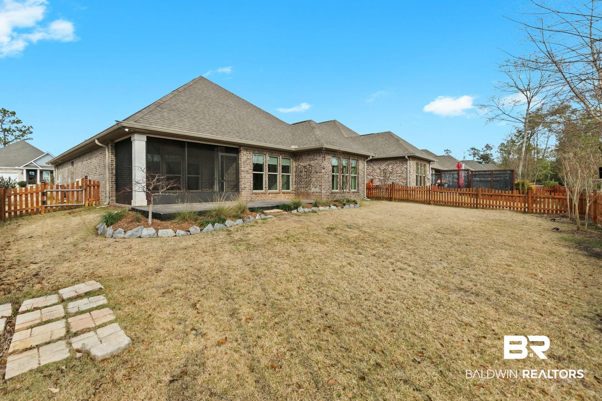 31654 Canopy Loop Daphne, AL 36527 - Photo 52 of 64 Rear view of house with a sunroom, brick siding, and a fenced backyard