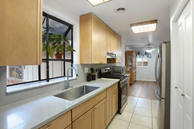 a kitchen with a sink and a refrigerator