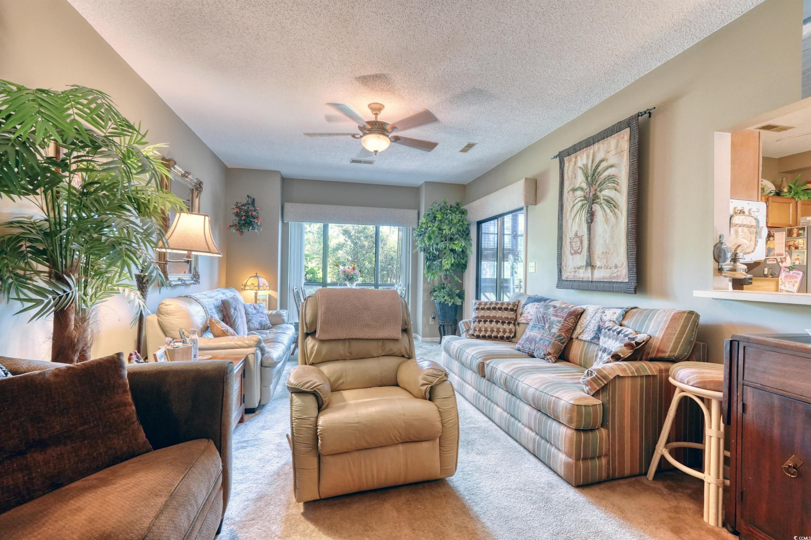1102 Indian Wells Court, Unit 2 Murrells Inlet, SC 29576 - Photo 3 of 22 Living room with light colored carpet, a textured ceiling, and a ceiling fan