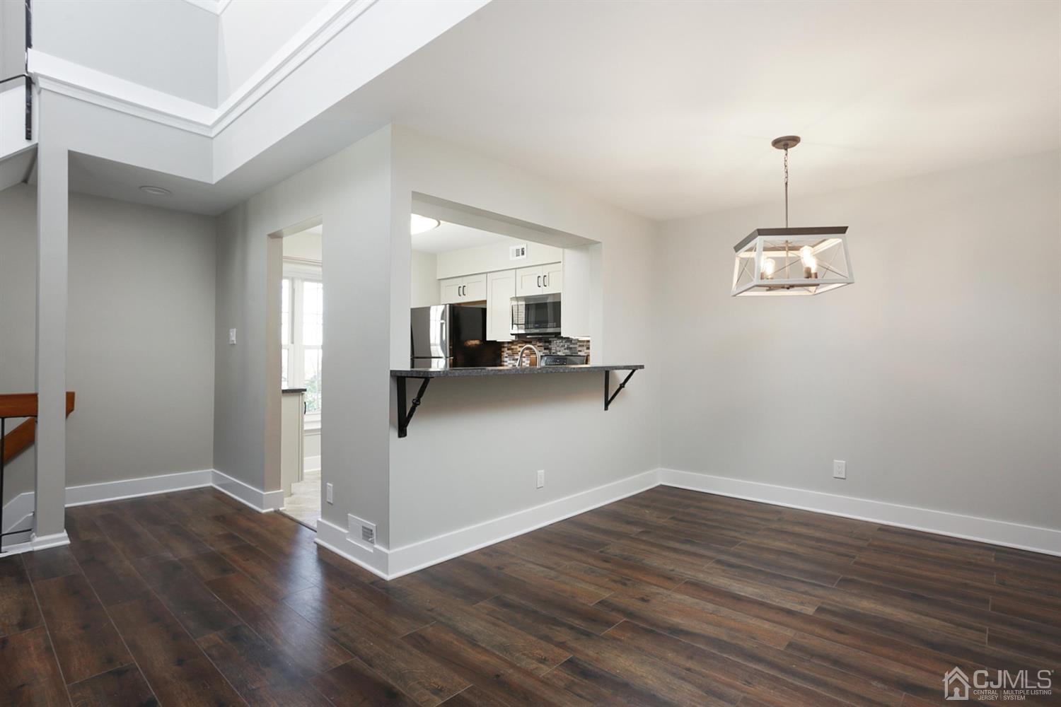 205 Commons Way Drive, Unit 5 East Brunswick, NJ 08816 - Photo 12 of 22 a view of kitchen with hallway and wooden floor