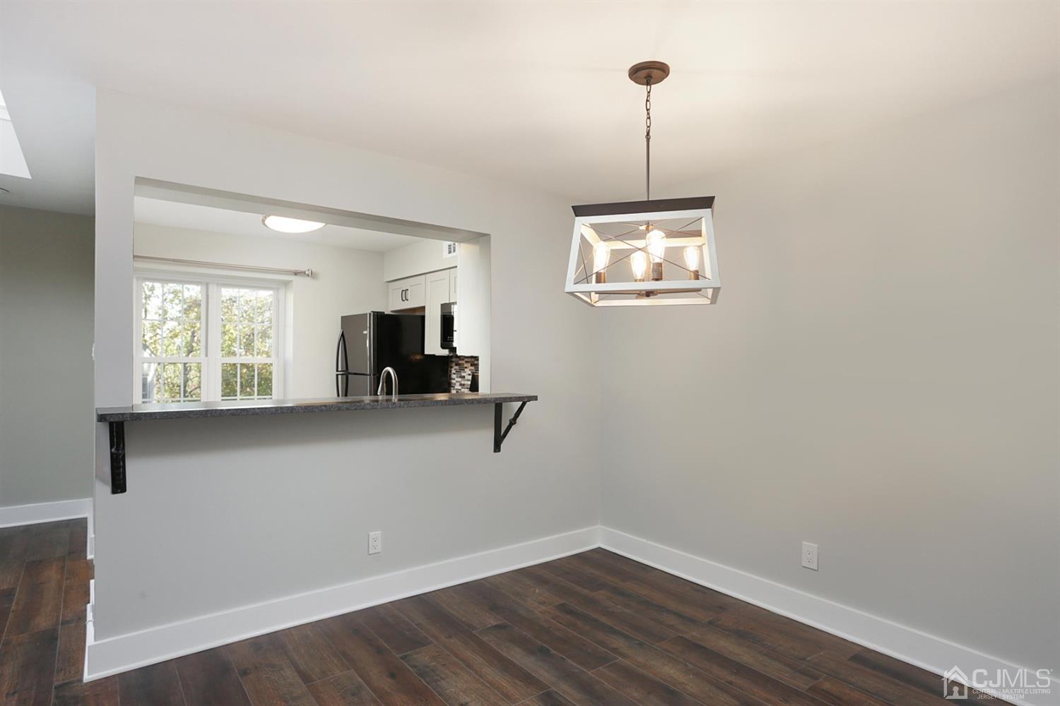 205 Commons Way Drive, Unit 5 East Brunswick, NJ 08816 - Photo 13 of 22 a view of a room with wooden floor and a window