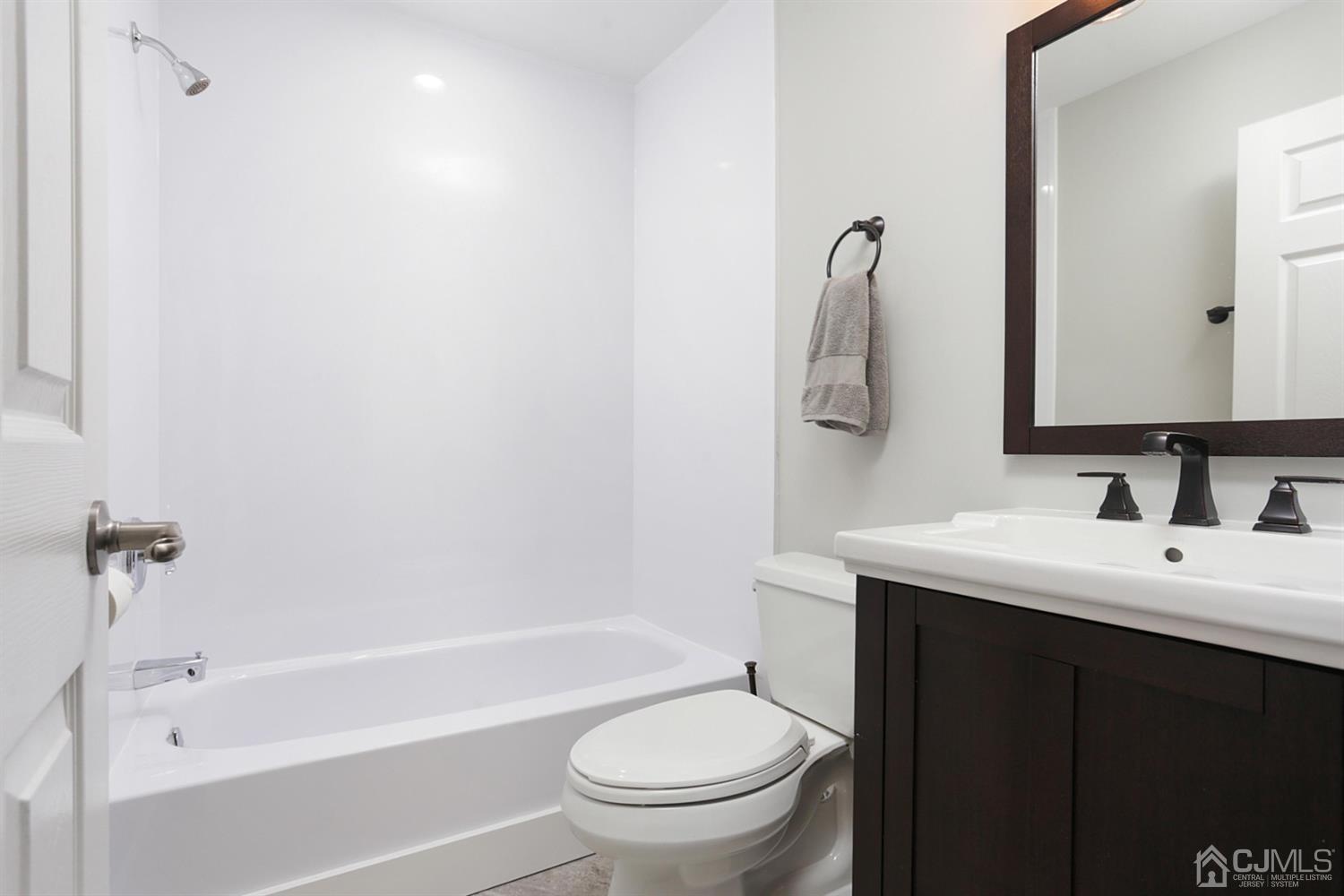 205 Commons Way Drive, Unit 5 East Brunswick, NJ 08816 - Photo 15 of 22 a bathroom with a sink a toilet and shower