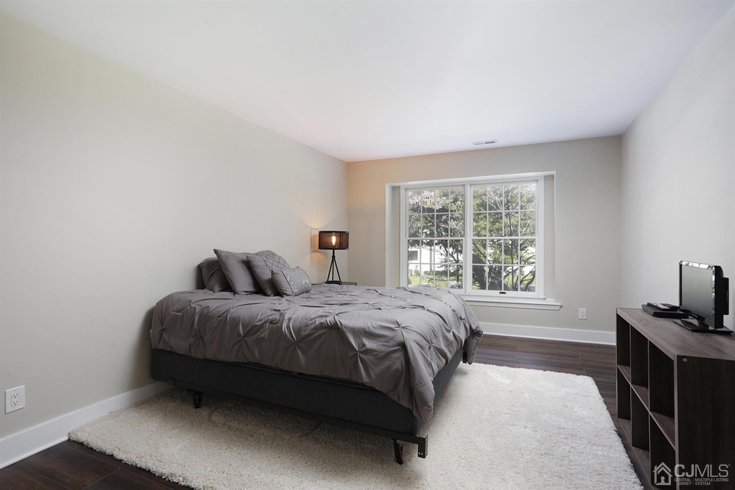 205 Commons Way Drive, Unit 5 East Brunswick, NJ 08816 - Photo 17 of 22 a bedroom with a bed and a window