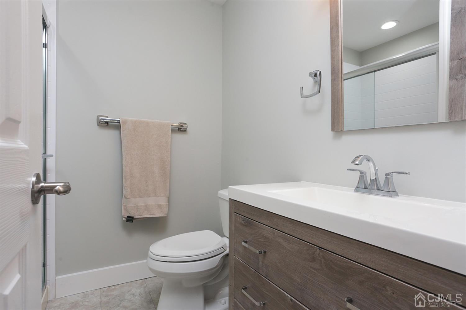 205 Commons Way Drive, Unit 5 East Brunswick, NJ 08816 - Photo 18 of 22 a bathroom with a sink toilet and mirror