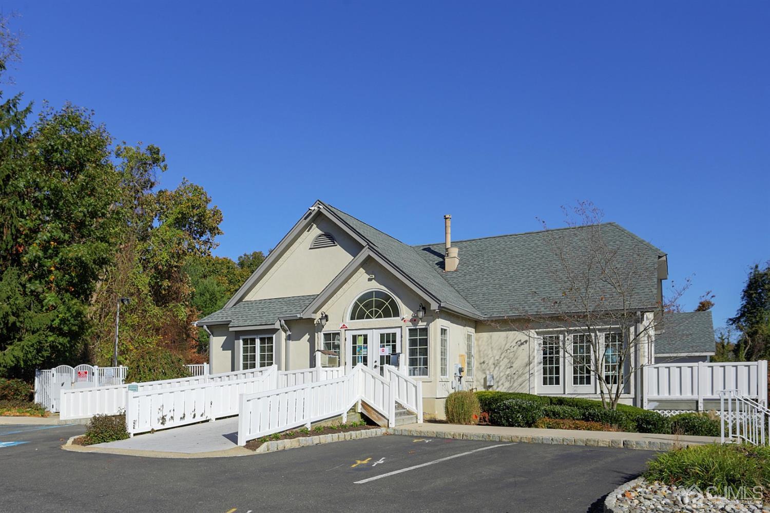 205 Commons Way Drive, Unit 5 East Brunswick, NJ 08816 - Photo 20 of 22 a front view of a house with a yard