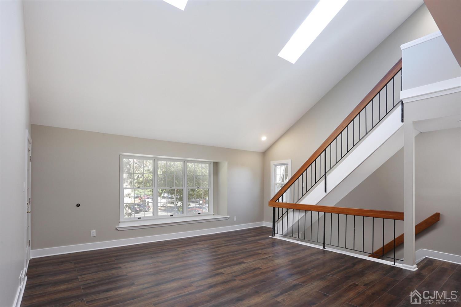 205 Commons Way Drive, Unit 5 East Brunswick, NJ 08816 - Photo 6 of 22 a view of an entryway with wooden floor and door