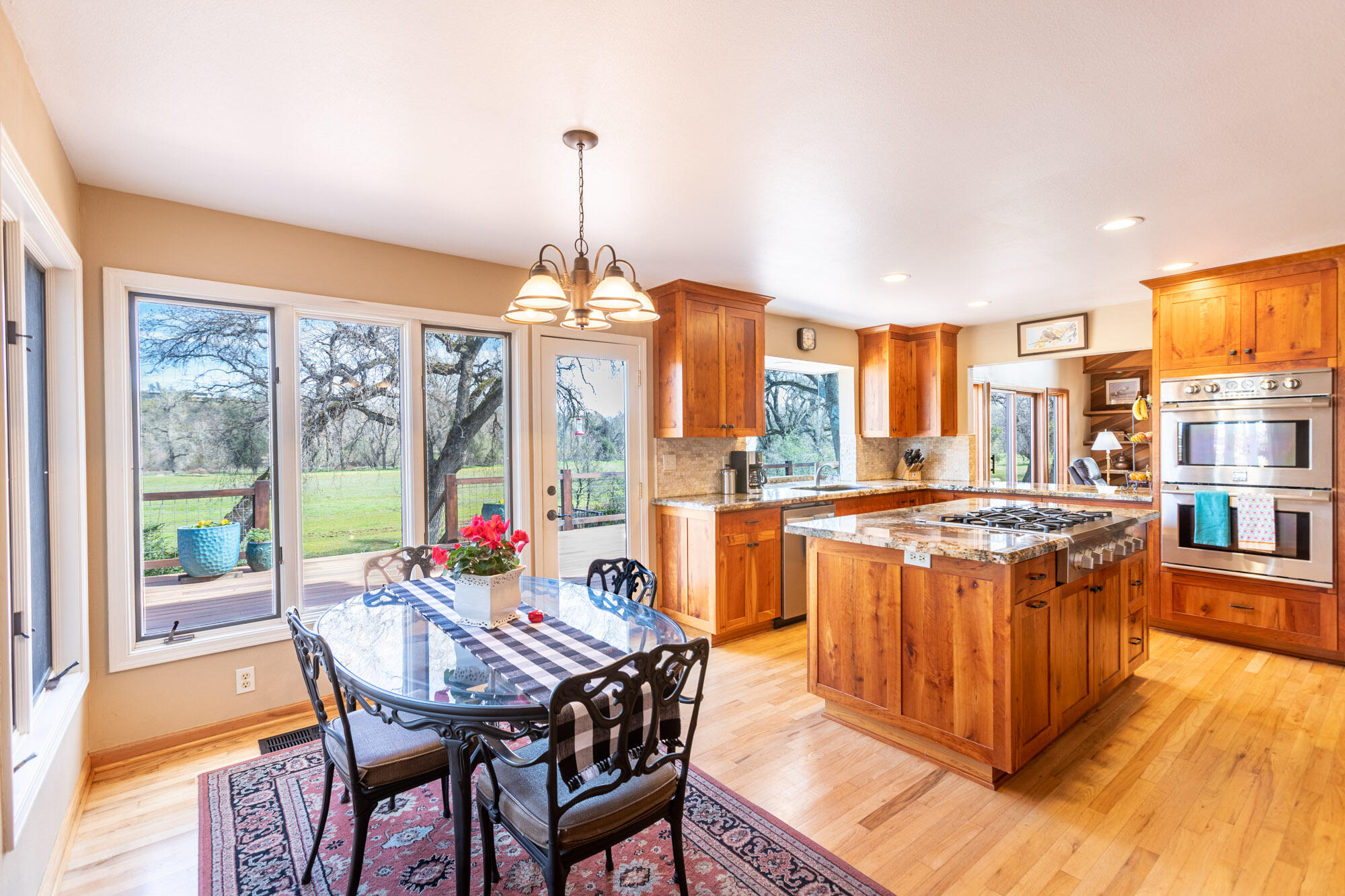 23848 Springwood Way Millville, CA 96062 - Photo 23 of 99 a view of a dining room with furniture a chandelier and wooden floor