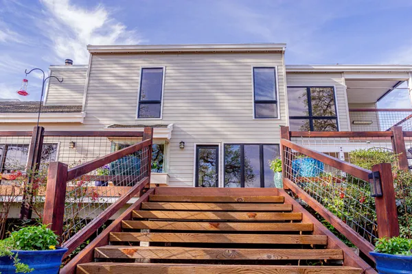 an aerial view of a house with garden space and street view