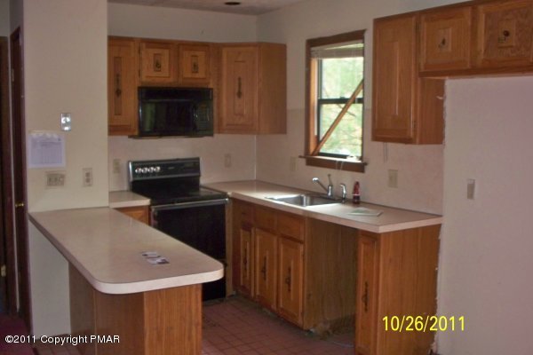 701 Edgewood Road Tobyhanna, PA 18466 - Photo 5 of 8 a kitchen with a sink a stove and cabinets