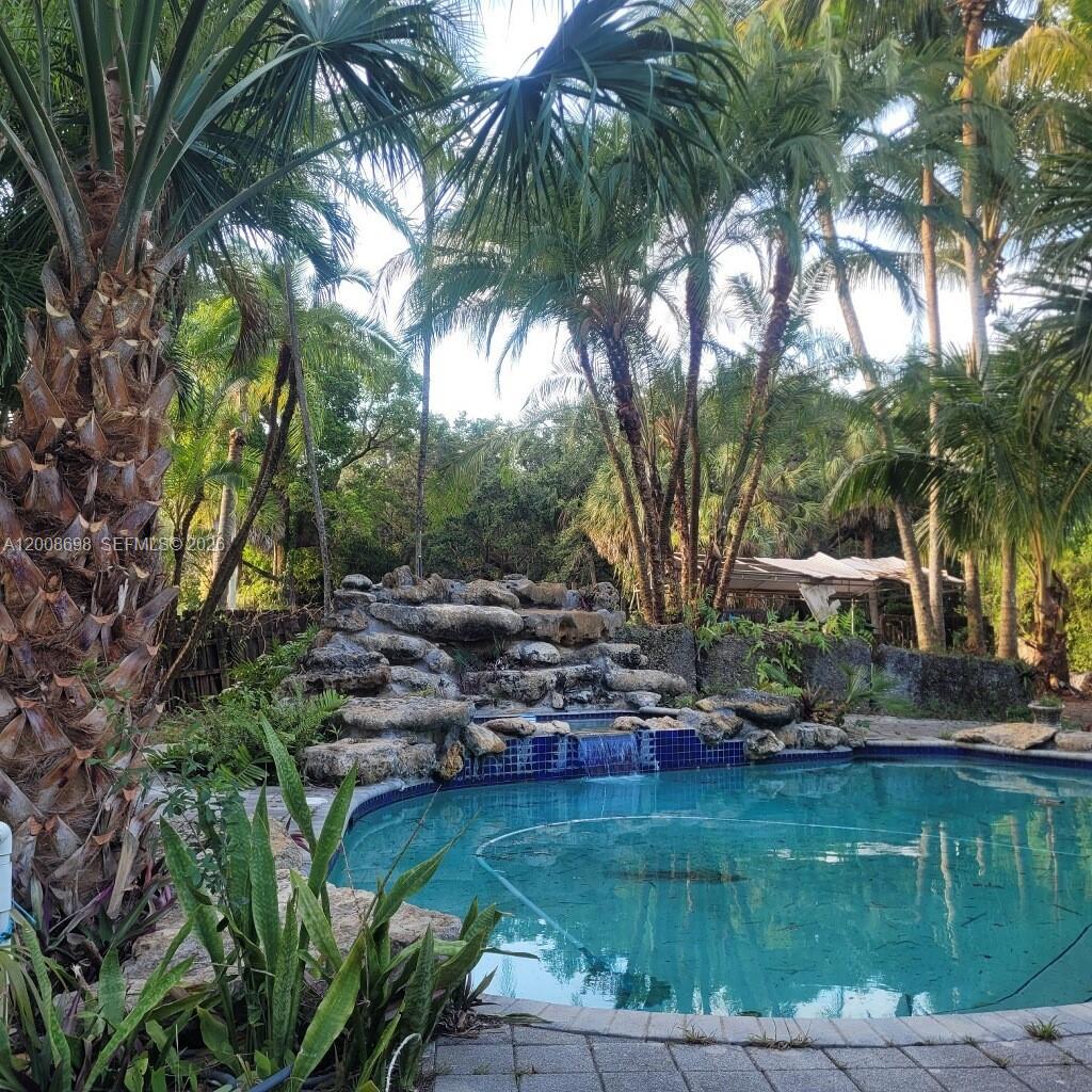 8339 Southwest 112th Street Miami, FL 33156 - Photo 13 of 30 a view of backyard with swimming pool