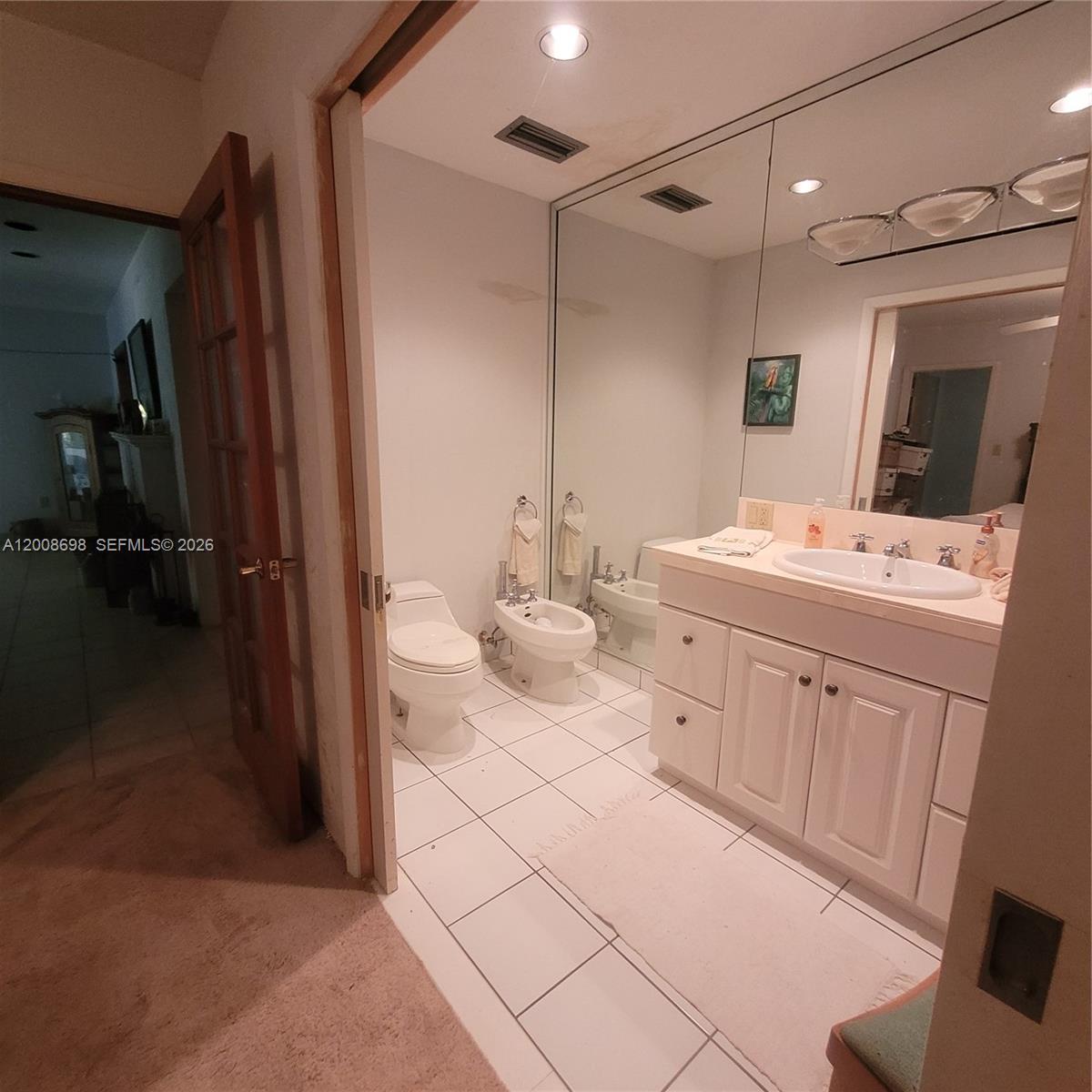 8339 Southwest 112th Street Miami, FL 33156 - Photo 14 of 30 a spacious bathroom with a double vanity sink a mirror and a shower