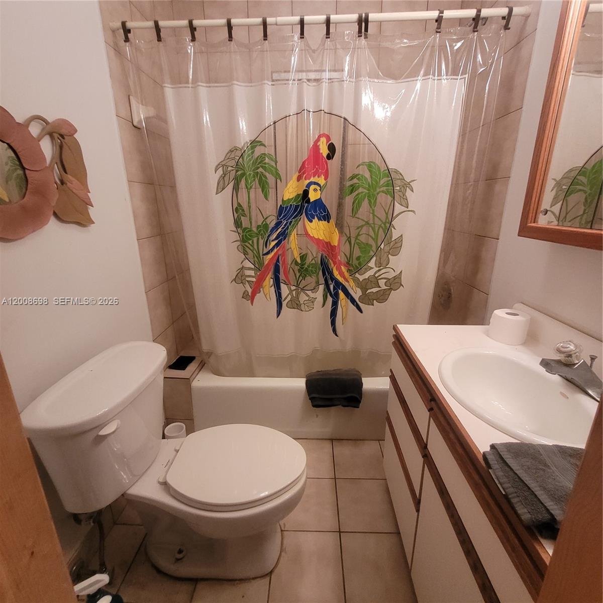 8339 Southwest 112th Street Miami, FL 33156 - Photo 16 of 30 a bathroom with a toilet sink and mirror