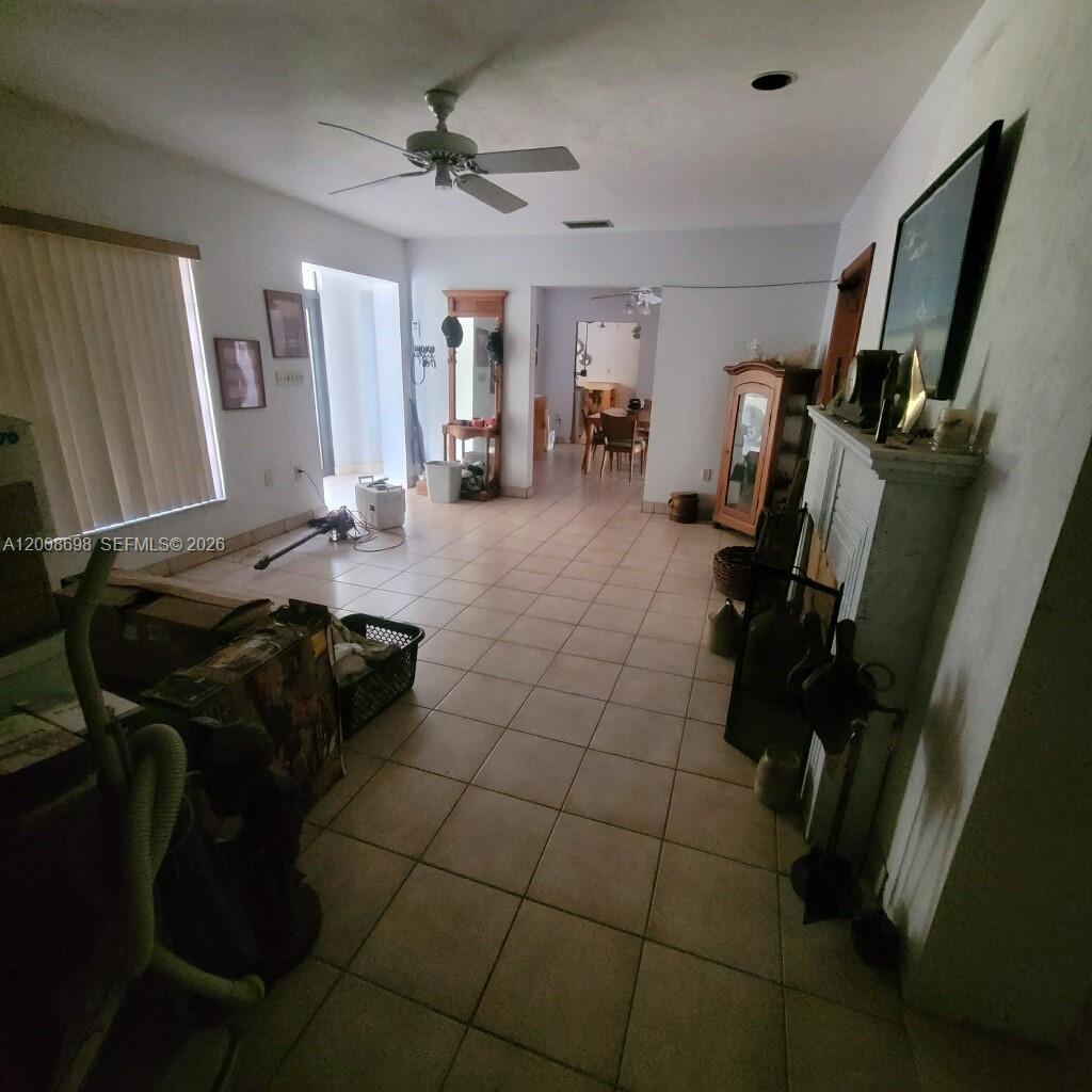8339 Southwest 112th Street Miami, FL 33156 - Photo 23 of 30 a living room with furniture and a flat screen tv