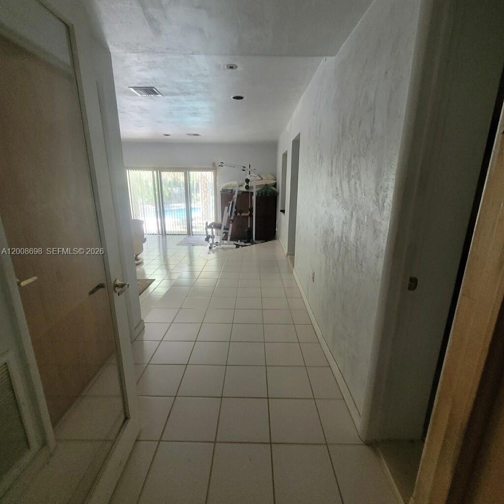 8339 Southwest 112th Street Miami, FL 33156 - Photo 24 of 30 a view of empty room with wooden floor and fan