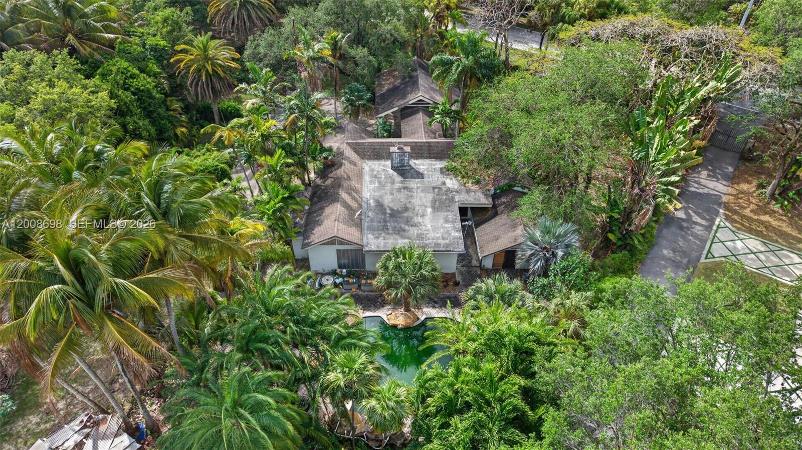 8339 Southwest 112th Street Miami, FL 33156 - Photo 7 of 30 an aerial view of a house with a yard and large trees