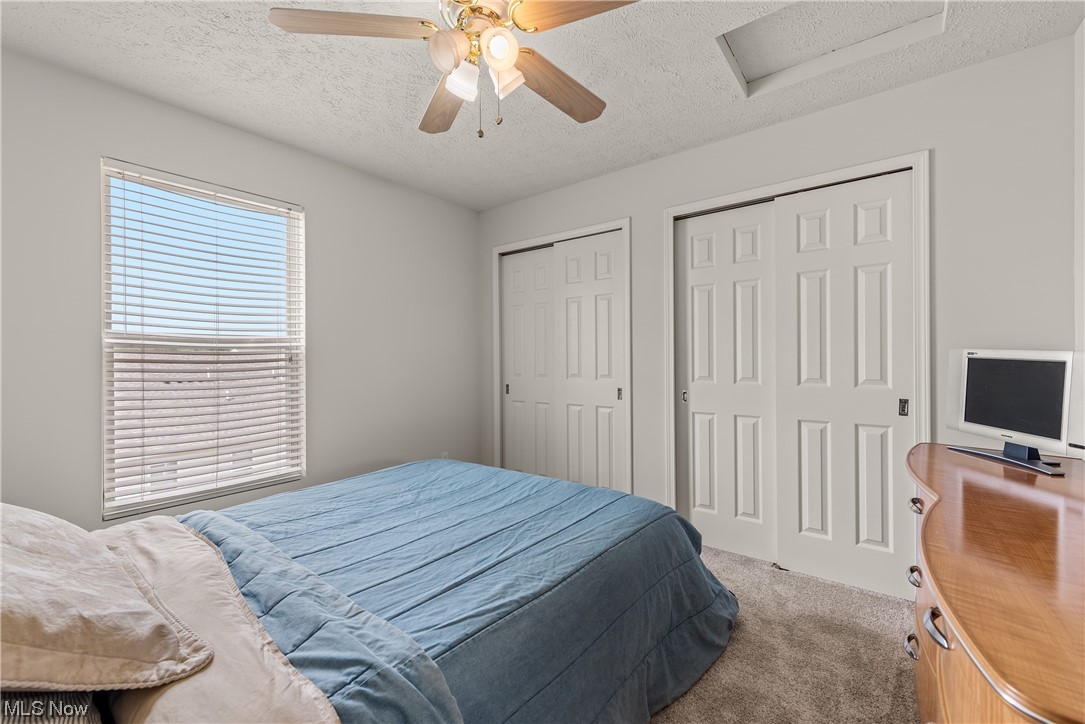 3967 Gardiner Run Akron, OH 44321 - Photo 26 of 35 Carpeted bedroom featuring ceiling fan and a textured ceiling