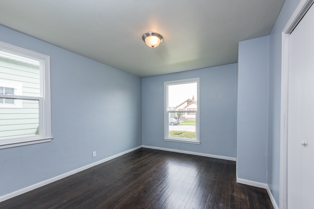 1111 Jones Avenue Racine, WI 53402 - Photo 11 of 27 an empty room with wooden floor and windows