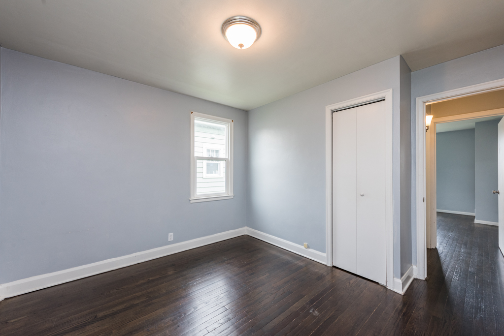 1111 Jones Avenue Racine, WI 53402 - Photo 14 of 27 an empty room with wooden floor and windows