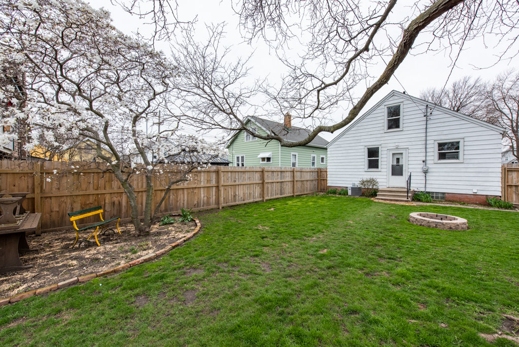 1111 Jones Avenue Racine, WI 53402 - Photo 24 of 27 a view of a backyard with table and chairs and a large tree