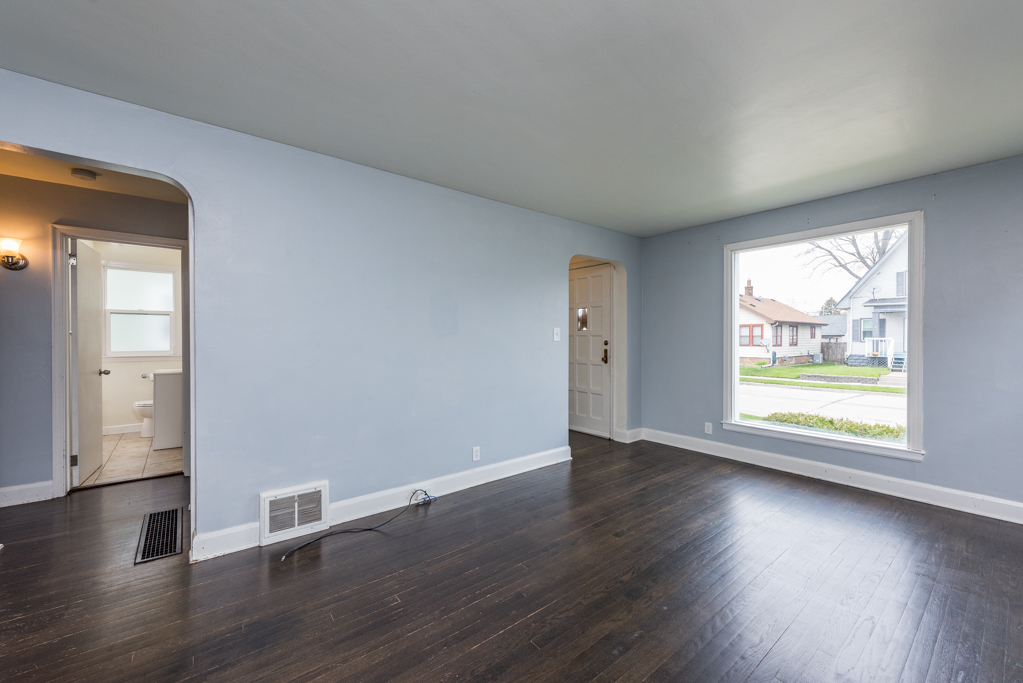 1111 Jones Avenue Racine, WI 53402 - Photo 5 of 27 an empty room with wooden floor and windows