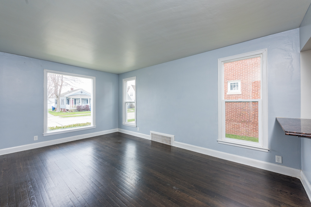 1111 Jones Avenue Racine, WI 53402 - Photo 6 of 27 a view of an empty room with wooden floor and a window