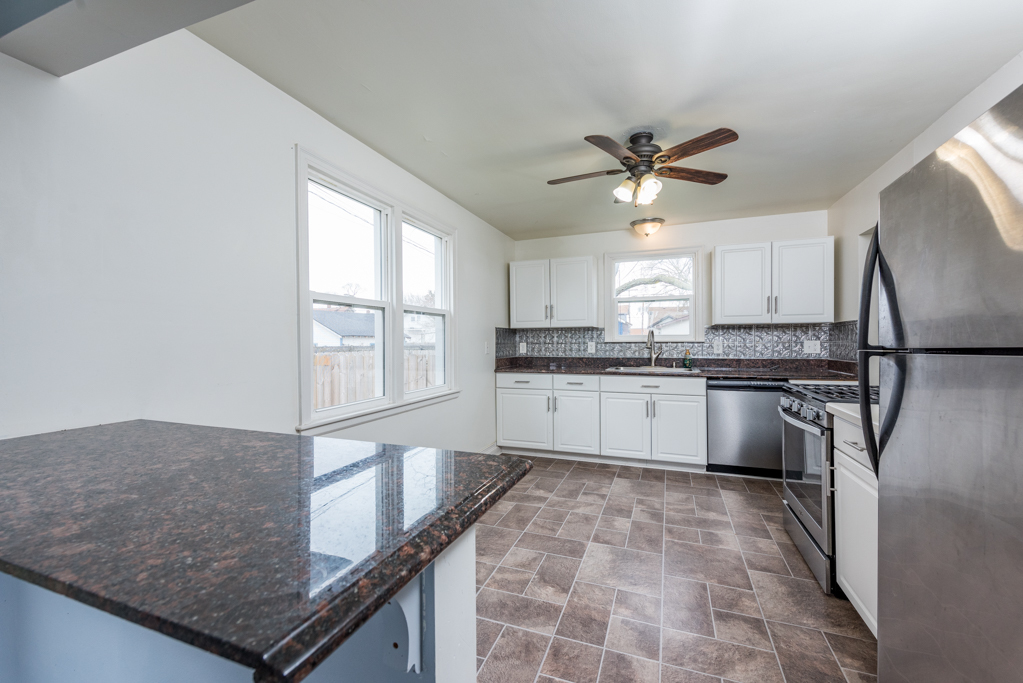 1111 Jones Avenue Racine, WI 53402 - Photo 7 of 27 a kitchen with a stove a sink and a refrigerator