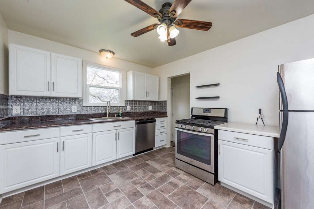 1111 Jones Avenue Racine, WI 53402 - Photo 8 of 27 a kitchen with granite countertop stainless steel appliances sink and cabinets