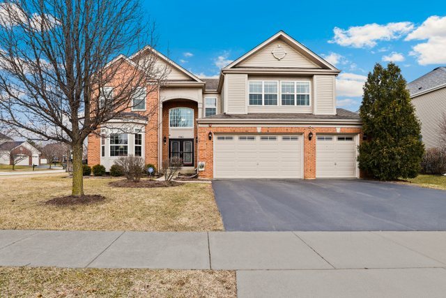 a front view of a house with a yard and garage