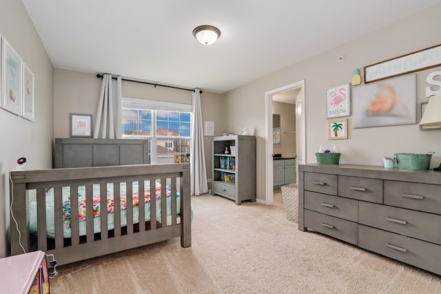 5961 Chatham Drive Hoffman Estates, IL 60192 - Photo 24 of 39 a bedroom with furniture and a window
