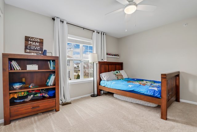 5961 Chatham Drive Hoffman Estates, IL 60192 - Photo 29 of 39 a bedroom with a bed and a window
