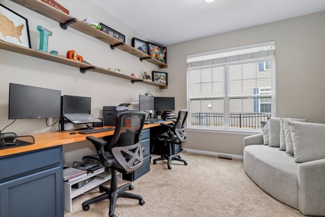 5961 Chatham Drive Hoffman Estates, IL 60192 - Photo 32 of 39 a view of a workspace with furniture and a window