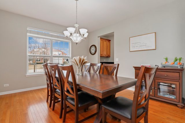 5961 Chatham Drive Hoffman Estates, IL 60192 - Photo 6 of 39 a view of a dining room with furniture wooden floor and chandelier