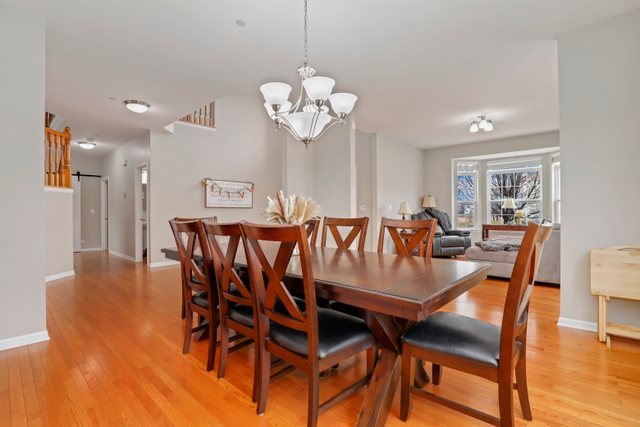 5961 Chatham Drive Hoffman Estates, IL 60192 - Photo 7 of 39 a view of a dining room with furniture and wooden floor