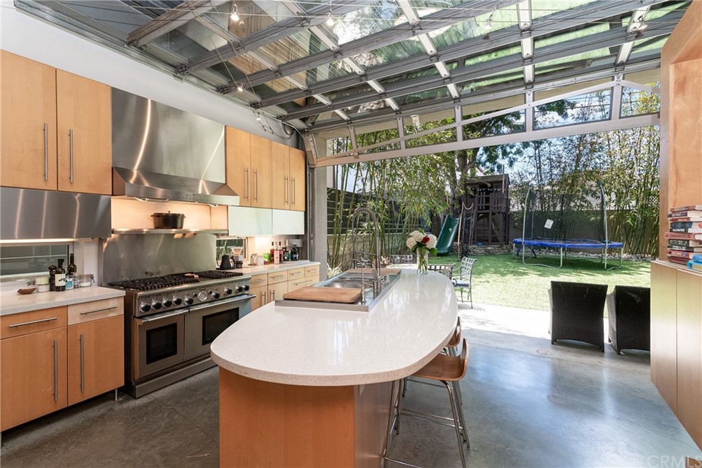 1149 Pine Avenue Manhattan Beach, CA 90266 - Photo 13 of 48 a kitchen with a stove a sink and a wooden cabinets