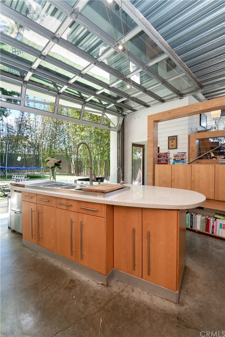 1149 Pine Avenue Manhattan Beach, CA 90266 - Photo 14 of 48 a dining hall with stainless steel appliances granite countertop a sink and wooden floors