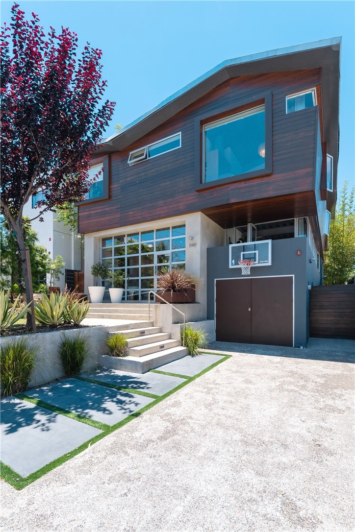 1149 Pine Avenue Manhattan Beach, CA 90266 - Photo 2 of 48 a front view of a house with a yard and garage