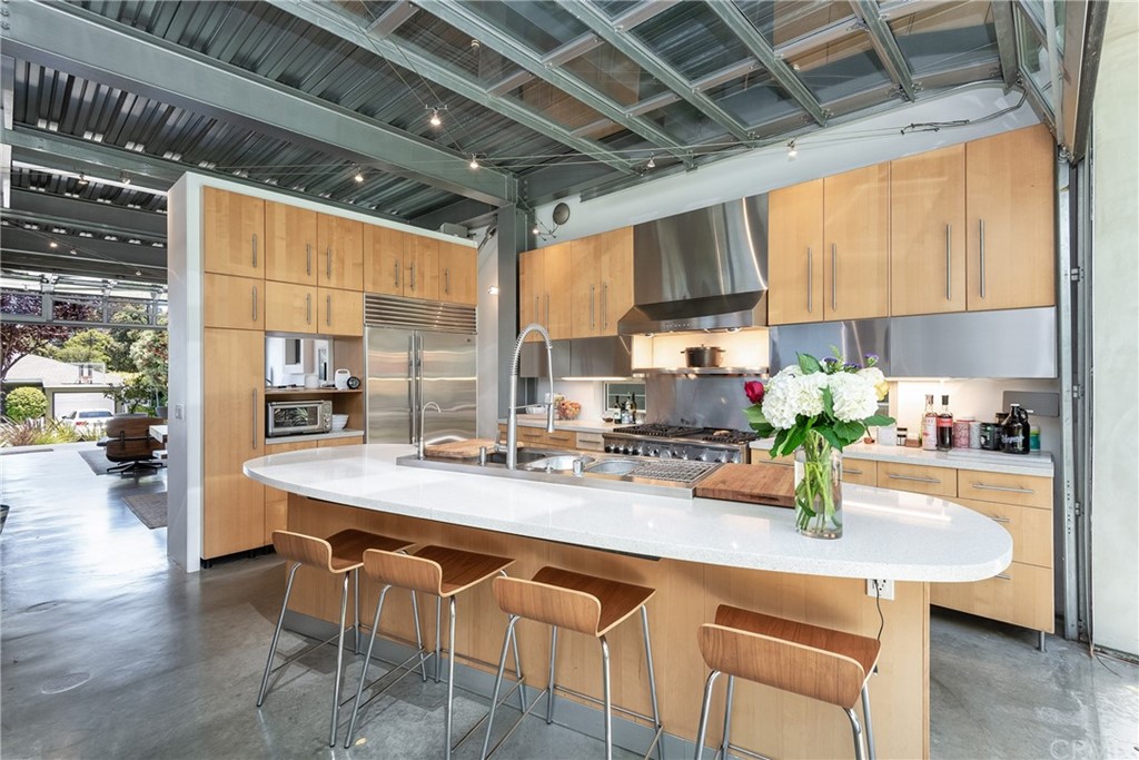1149 Pine Avenue Manhattan Beach, CA 90266 - Photo 22 of 48 a kitchen with a sink a counter and chairs