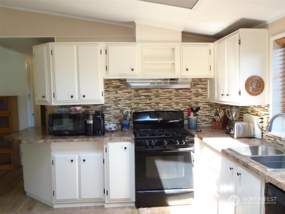 843 Sherburne Road Sequim, WA 98382 - Photo 14 of 40 a kitchen with stainless steel appliances granite countertop a stove and a sink