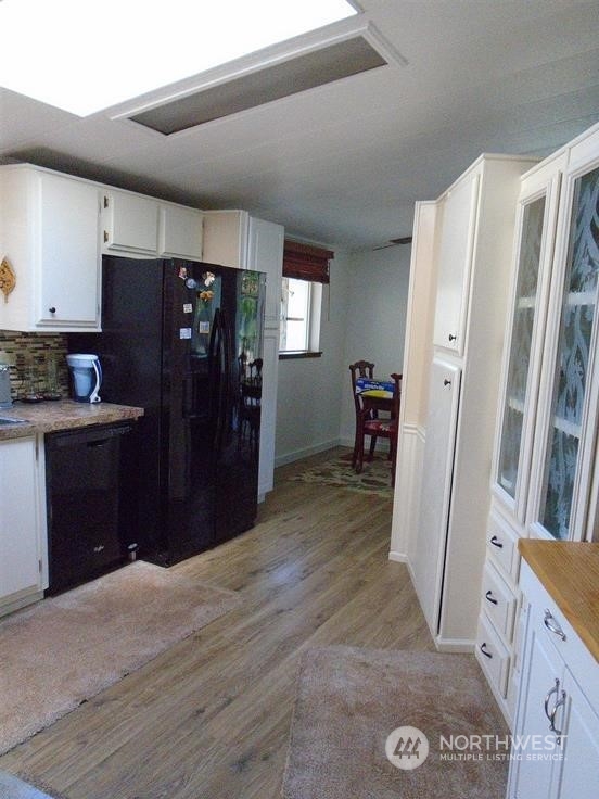 843 Sherburne Road Sequim, WA 98382 - Photo 16 of 40 a view of a kitchen with refrigerator and wooden floor